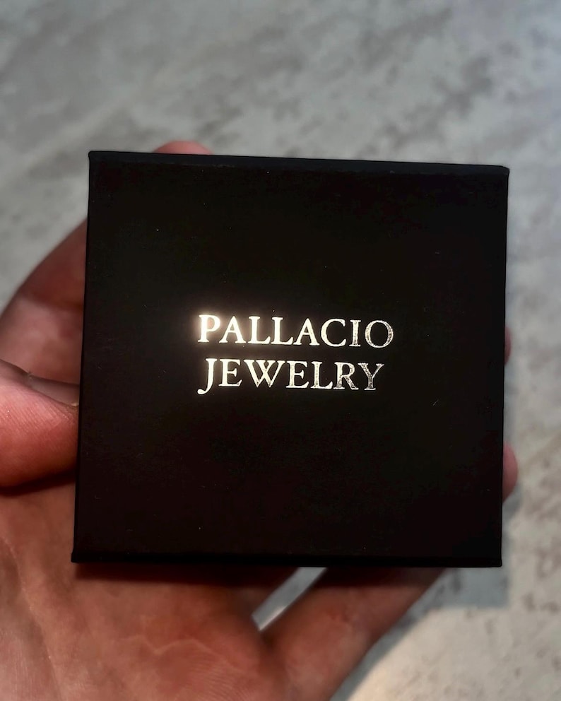 May include: A black jewelry box with the words "PALLACIO JEWELRY" printed in gold lettering.
