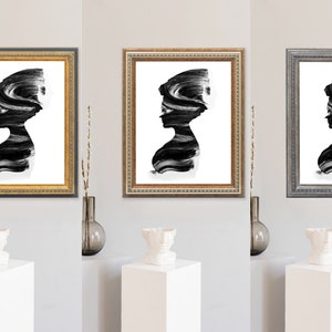 May include: Three framed black and white abstract art prints of a woman's silhouette with brushstrokes. The frames are gold, silver, and black.