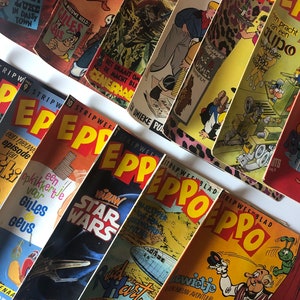 以下が含まれることがあります： 「ラッキー・ルーク」、「ジール・デ・ゲウス」、「将軍」、「ペッポ」、「スター・ウォーズ」、「ルード・ハート」など、さまざまなキャラクターとタイトルをフィーチャーした、ビンテージコミックのコレクションです。