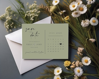 May include: A sage green wedding save-the-date card with the text "Save the Date" in elegant script. The card includes a calendar for July 2020 and the names "Emily & John." The card is accompanied by a white envelope and floral accents.