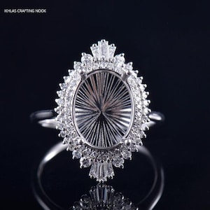 925 Sterling Silver Custom Halo Style Oval Cut Ring Setting can fit a 13.0×10.0mm Oval Cut center stone, accented with small Zircons.