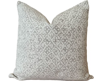 May include: A white and gray patterned throw pillow with a geometric design.