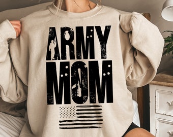 May include: A beige sweatshirt with the text "ARMY MOM" in black with a silhouette of a soldier and a small American flag.