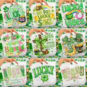 May include: A selection of white fabric items with St. Patrick's Day designs. Each features green and gold accents, shamrocks, rainbows, pots of gold, and the word "Lucky" in various fonts. Some include phrases like "Oh for Luck's Sake" and "Lucky Vibes."