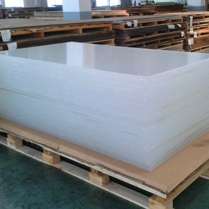 May include: A stack of clear acrylic sheets on a wooden pallet. The sheets are stacked neatly and are ready to be shipped.