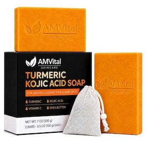 May include: Two rectangular orange soap bars with the AMVital Skincare logo embossed on the front, a black product box labeled Turmeric Kojic Acid Soap, and a small white mesh drawstring bag for lathering, with a net weight of 7 ounces total.