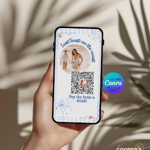 May include: A smartphone screen showing a digital invitation with the text "Last Toast on the coast" and "Buy the bride a drink!". The design features a couple's photo, a QR code, and blue decorative elements.