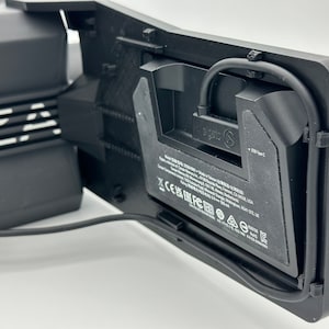 May include: Black VR headset with a black cable attached to the side. The headset has a white logo that says "Oculus" and a label with the text "1 USB Type-C".