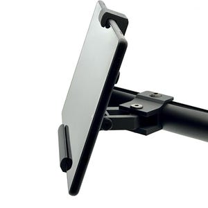 May include: A black tablet holder with a curved arm and adjustable clamp. The holder is designed to securely hold a tablet, with a sleek, modern design. The holder is made of metal and has a matte finish.