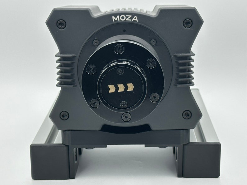 May include: A black MOZA camera stabilizer with a silver base and a black control knob with a directional arrow indicator.