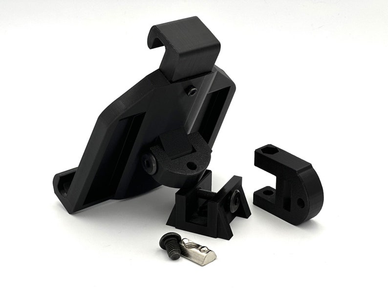 May include: Black plastic phone mount with a swivel arm and a clamp. The mount is disassembled and includes two screws.