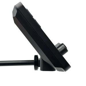 May include: A black electronic device with buttons and a textured knob. The device is mounted on a black rod and angled upwards. The background is plain white.