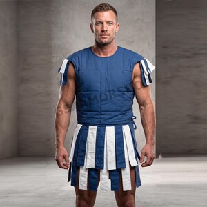 May include: A blue and white padded costume, featuring a sleeveless top and a pleated skirt. The top has a quilted design, and the skirt alternates blue and white vertical stripes. The costume is designed for historical reenactment or theatrical use.
