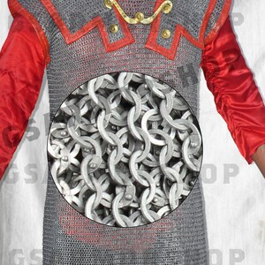 May include: A silver chainmail shirt with red trim. The chainmail is made of interlocking metal rings.