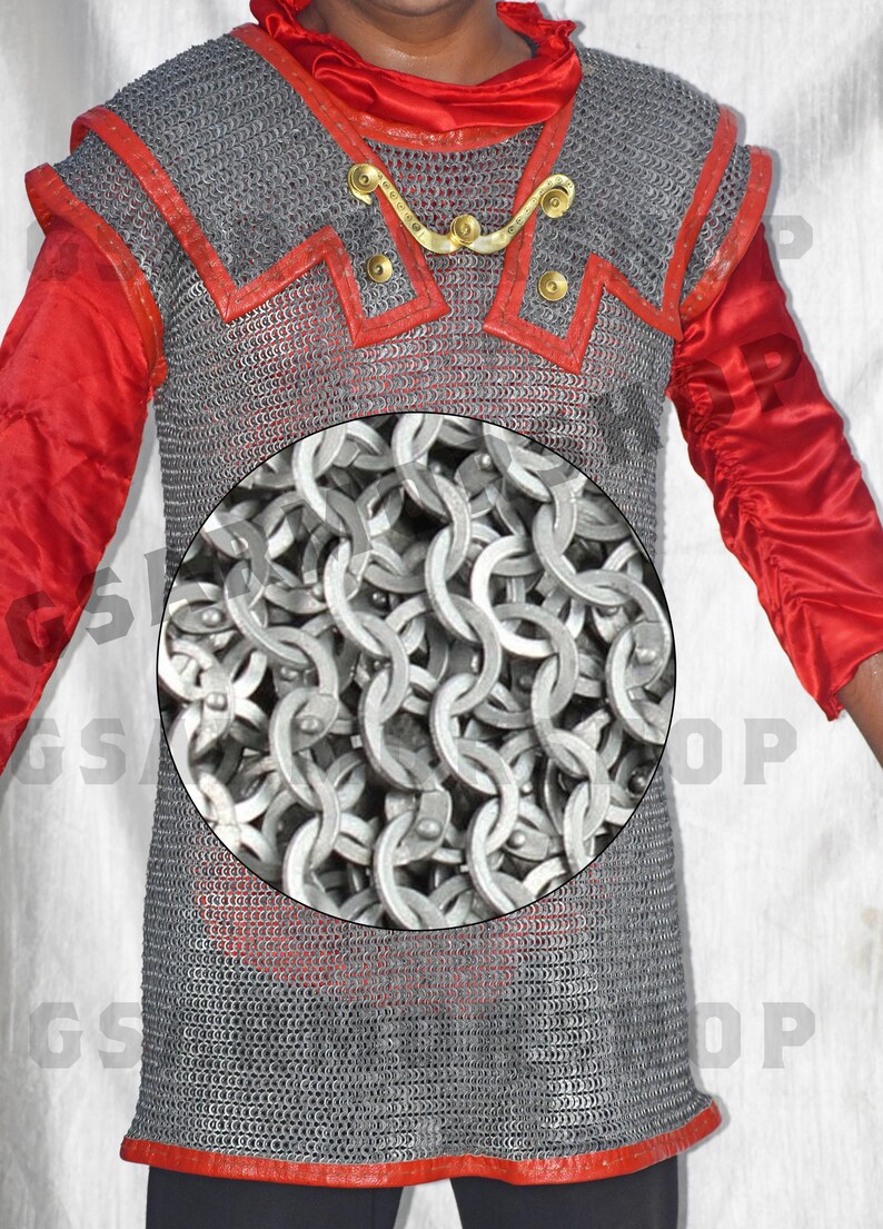 May include: A silver chainmail shirt with red trim. The chainmail is made of interlocking metal rings.