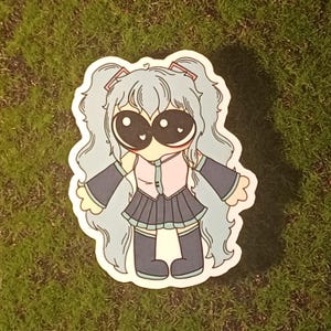 May include: A sticker of a cartoon character with blue hair, wearing a pink shirt, a blue skirt, and black boots. The character has large eyes with hearts in them.