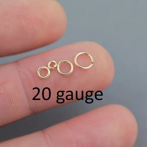 May include: Four gold jump rings of different sizes, 20 gauge, on a finger.