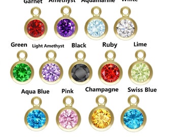 May include: Assortment of 12 gold-tone charm pendants with different colored gemstones. The gemstones are: garnet, amethyst, aquamarine, white, green, light amethyst, black, ruby, lime, aqua blue, pink, and champagne.