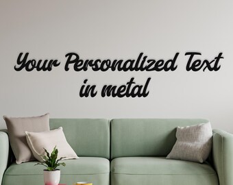 May include: A modern living room with a light green sofa, cushions, and a glass coffee table. The wall above the sofa has the text "Your Personalized Text in metal" in black cursive. A yellow teacup sits on the table.