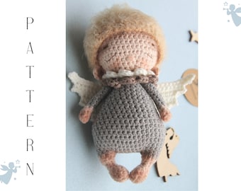 May include: A crocheted angel doll with a gray dress, white wings, and a light brown face. The doll has a light brown curly hair and a white crocheted collar.