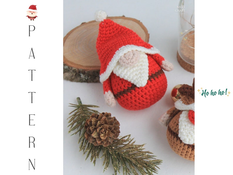 May include: A crocheted Santa Claus ornament with a red hat, white beard, and brown belt. The ornament is sitting on a wooden surface with a pine branch and a pine cone.