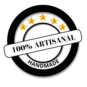 May include: A circular black and white badge with the words "100% ARTISANAL HANDMADE" in black text. Five gold stars are arranged in an arc above the text. The badge is on a white background.