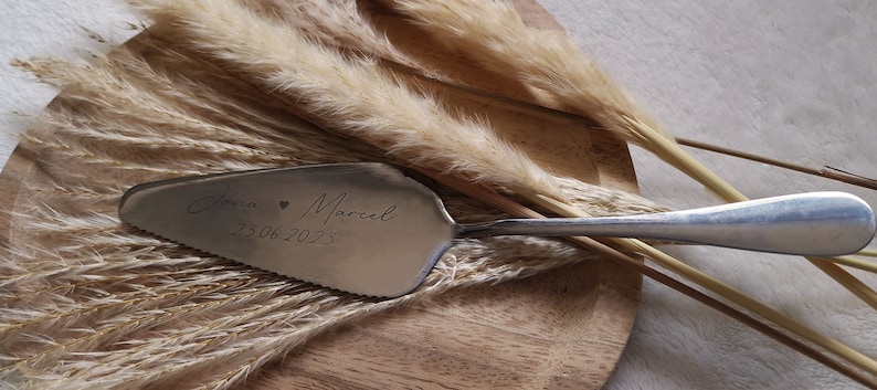 Personalisierter Tortenheber in Silber oder Gold – eine edle und praktische Ergänzung für Hochzeiten, Geburtstage oder Jubiläen. Mit individueller Gravur wird der Tortenheber zu einem besonderen Highlight auf jeder Feier und einem einzigartigen Erinnerungsstück. Ideal als Geschenk zur Hochzeit, Verlobung oder als liebevolles Mitbringsel für Backliebhaber.