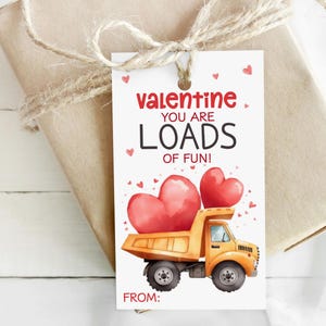 May include: A Valentine's Day gift tag with a watercolor illustration. The tag features a yellow dump truck carrying two red hearts, with the text "Valentine, You Are Loads of Fun!" and space for a "From:" message.