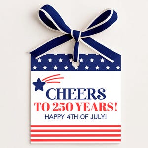 May include: A patriotic gift tag with a blue and white ribbon. The tag features a blue background with white stars, a red and white striped bottom, and the text "Cheers to 250 Years! Happy 4th of July!"