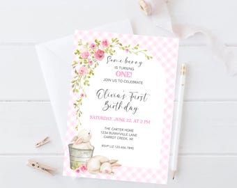 May include: A pink and white gingham patterned birthday invitation with floral accents. The invitation reads "Some bunny is turning ONE!" and includes details for Olivia's first birthday.