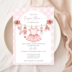 May include: Pink birthday invitation with the text "Our Little Sugar Plum is Turning One!" featuring illustrations of a ballet dress, ballet shoes, and a nutcracker. The invitation includes event details.