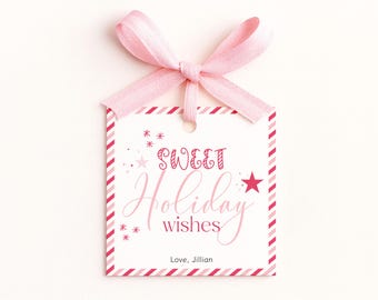 May include: A square white gift tag with a pink ribbon bow at the top. The tag features a red and pink striped border and the text Sweet Holiday wishes in pink and red script. A small red star and pink starbursts decorate the tag.