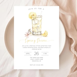 May include: A watercolor invitation for a Spring Soiree. The design features a refreshing drink with lemon slices, ice, and a straw. The invitation includes the date, time, and location.