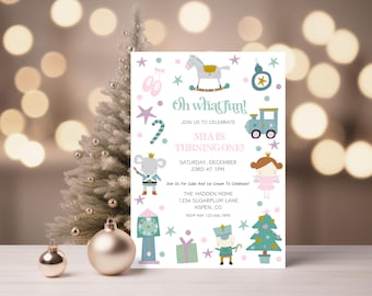 May include: A festive invitation with the text "Oh what fun!" announces Mia's first birthday. The design features whimsical illustrations of a rocking horse, train, and fairy, with a Christmas tree and ornaments in the background.