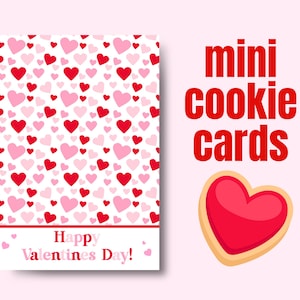 May include: Valentine's Day mini cookie cards with a heart-shaped cookie illustration. The card features a pattern of red and pink hearts on a white background, with the text "Happy Valentine's Day!" in a red font.