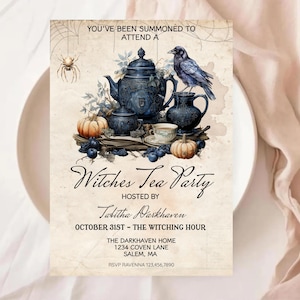 May include: An invitation for a Witches Tea Party. The design features a blue teapot, a raven, pumpkins, and the text "Witches Tea Party". The invitation is hosted by Tabitha Darkhaven and is for October 31st.