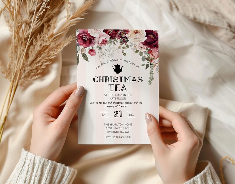 May include: A Christmas tea party invitation with a floral design. The invitation features a teapot icon and the text "Christmas Tea" in black lettering. The invitation is for Saturday, December 21st at 1 o'clock in the afternoon. The Hamilton Home is located at 1234 Jingle Lane, Evergreen, CO. RSVP to Liz at 123.456.7890.