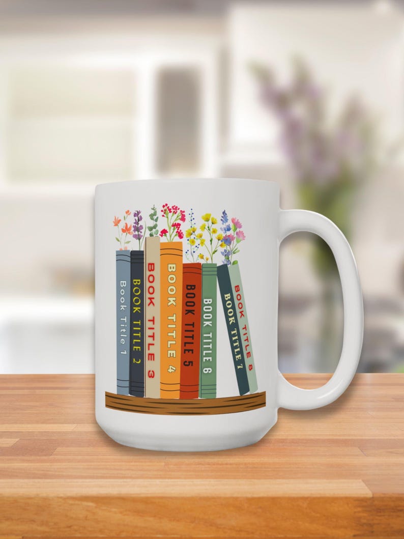 Left hand side of White 15 oz mug with seven books on a shelf with wildflowers for bookmarks. Book titles can be customized to a person's favorite books.