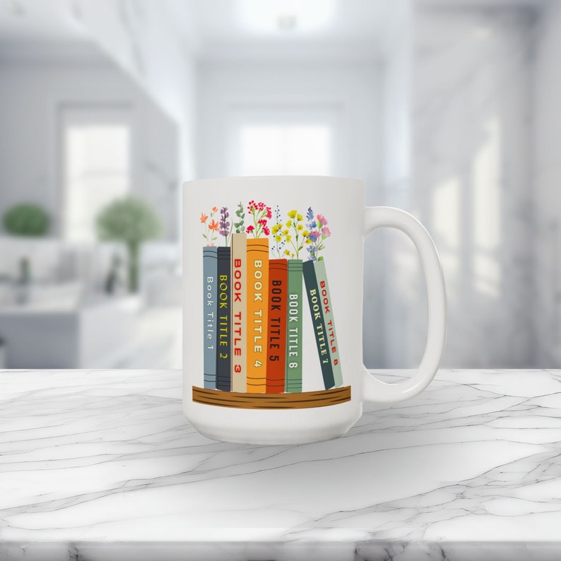 White 15 oz mug with seven books on a shelf with wildflowers for bookmarks. Book titles can be customized to a person's favorite books.
