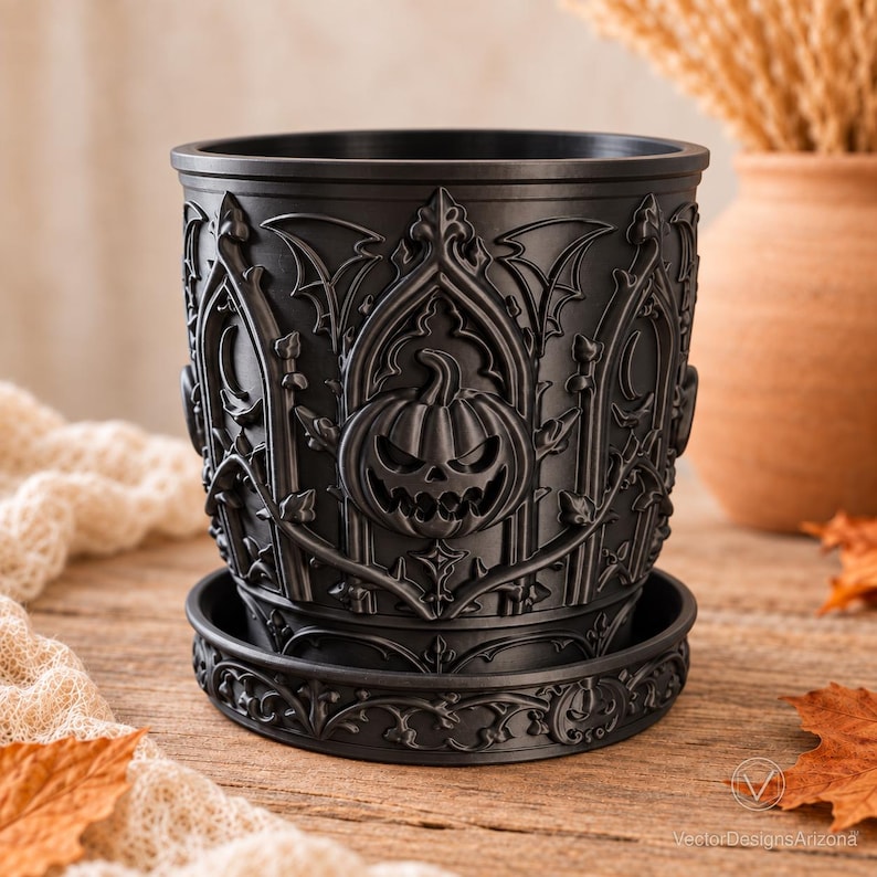 Matte black Gothic Pumpkin dry planter with matching saucer on a warm autumn tabletop.