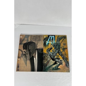 May include: A-1 comic book with a detailed illustration of two figures in combat. The cover has a dark colour scheme with the title "A-1" in a bold font. The background features a grid pattern.