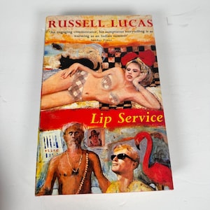 May include: A vintage paperback book titled "Lip Service" by Russell Lucas. The cover features a colorful illustration of a woman, a man, and a flamingo. The book has text from the Sunday Times.