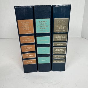 May include: Three Reader's Digest Condensed Books in a row. The books have dark blue covers with gold and teal labels. Titles include "An Az on the Flood", "The Seventh Secret", and "Break In".