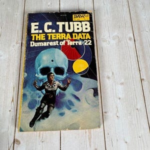 May include: Vintage paperback book titled "E.C. Tubb The Terra Data Dumarest of Terra 22". The cover features a science fiction illustration with a figure in a spacesuit, a skull, and geometric shapes in red and yellow.