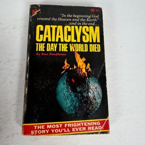 May include: A vintage paperback book titled "CATACLYSM THE DAY THE WORLD DIED" by Don Pendleton. The cover features a burning blue and black globe with flames. The text includes "In the beginning God created the Heaven and the Earth...and in the end..." and "THE MOST FRIGHTENING STORY YOU'LL EVER READ!"