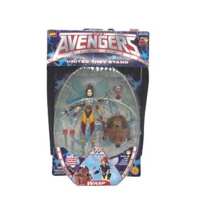 May include: The Avengers "United They Stand" Wasp action figure in original packaging. The figure is in a clear plastic bubble, with a brown and gold spherical device, and two red accessories. The packaging features the Avengers logo and the words "Wasp".