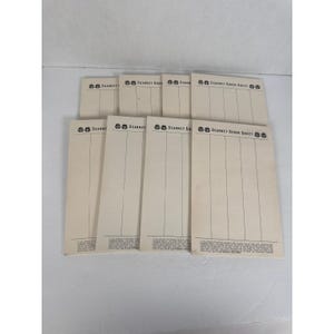 May include: A stack of vintage "Scarney Score Sheet" pads. The sheets are cream-colored with black printed text and vertical lines for keeping score. The top of each sheet has the "Scarney" logo.