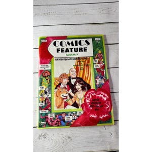 May include: A vintage comic book titled "COMICS FEATURE" with a green and red cover. The cover features illustrations of comic book characters and the text "February No. 9" and "AN INTERVIEW WITH LEONARD STARR".