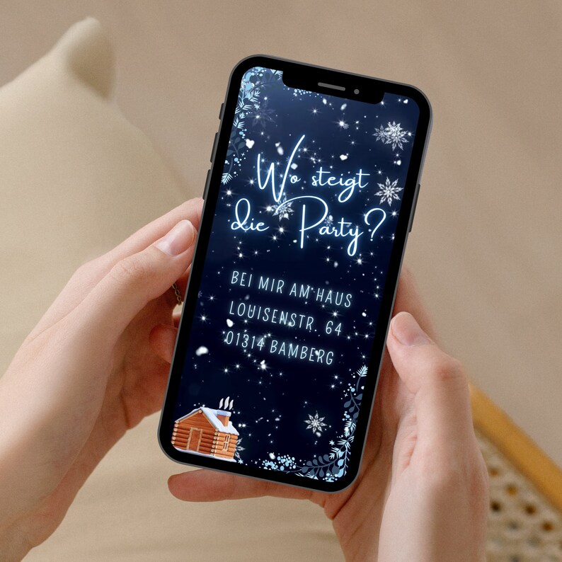 May include: A blue and white smartphone with a winter-themed background. The text on the screen reads "Wo steigt die Party?" with a small gingerbread house illustration. The text below the question reads "Bei mir am Haus Louisenstr. 64 01314 Bamberg".