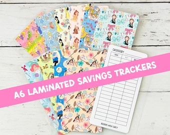May include: A collection of A6 laminated savings trackers featuring various colorful cartoon character patterns and a white tracker card with a grid for category, date, plus or minus, and balance, labeled with the text A6 LAMINATED SAVINGS TRACKERS.